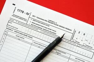 Indonesian tax form 1770-4 Individual Income Tax Return and pen on table photo