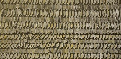 The old roof of an ancient barn, created from wooden shards, darkened by weather influences photo