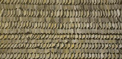 The old roof of an ancient barn, created from wooden shards, darkened by weather influences photo