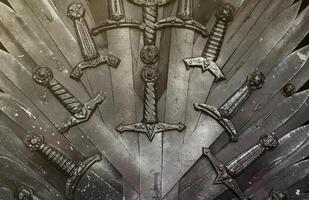 Metal knight swords background. The concept Knights photo