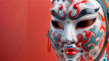 Traditional Chinese mask with red and white swirls embodies culture, opera, performance, and art photo