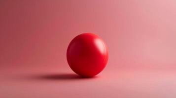 Red stress ball on pink background depicting relaxation, therapy, and anxiety relief photo
