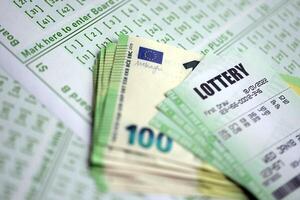 Green lottery tickets and euro money bills on blank with numbers for playing lottery photo