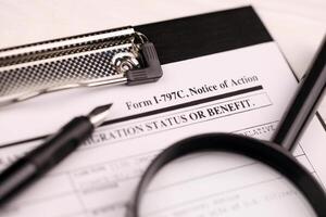 I-797c Notice of action blank form on A4 tablet lies on office table with pen and magnifying glass photo