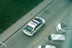 TERNOPIL, UKRAINE - JULY 7, 2023 Ukrainian patrol police white car with police lights and decals in daytime photo