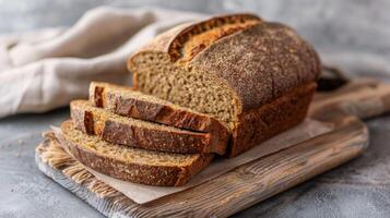 Rye bread sliced on rustic table with wholegrain and healthy food elements photo