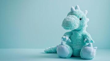 Turquoise dinosaur plush toy with soft fluffy texture in a clean studio setting photo