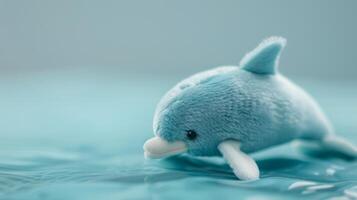 Blue plush dolphin toy floating on serene water in soft light photo