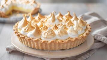 Lemon meringue pie with golden whipped peaks on a dessert plate photo