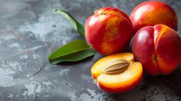 Nectarine fruit ripe and juicy with fresh sliced pieces displaying the vibrant seed and organic texture on a dark background photo