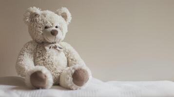 Beige Teddy bear with fluffy fur sitting comfortably with a soft bow tie photo