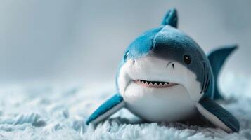 Plush blue and white shark toy with a fluffy texture and soft, stuffed appearance suitable for a child's playroom photo