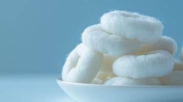 Close-up of cotton rings on a plate highlighting hygiene, beauty, and care with a focus on purity and softness photo