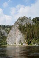 The name of the rock is Stone Haystack on the Belaya River, the nature of the native land of Bashkortostan, the landscapes of Russia is the Southern Urals. photo