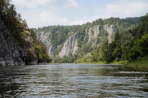 Beautiful landscape with rocks on the river in the wild, the calm surface of the mountain river, the nature of Russia, a trip on vacation. photo