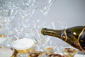 Party drink alcohol champagne, bottle drink into glass, martini on the party peramida wine photo