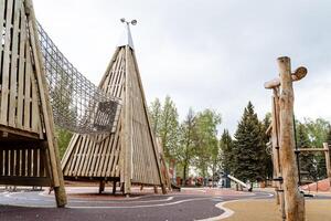 Wooden recreation park for children, obstacles for climbing kids, children's playground. photo