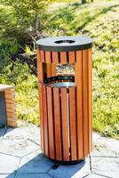 A round-shaped garbage can, a new waste container, a garbage can on the sidewalk, a lid for cigarette gobies, an ashtray outside, to put out a cigarette. photo