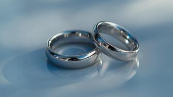 Silver shiny rings reflecting love and engagement with a wedding promise photo