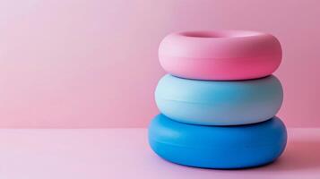 Stack of rubber doorstops in pink and blue pastel colors with a minimalistic home safety design photo