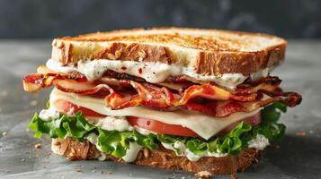 Gourmet BLT sandwich with bacon, lettuce, and tomato on toasted bread with mayonnaise photo