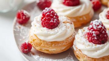 Delicious raspberry eclair with cream and icing on a sweet dessert plate photo