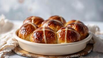 Delicious glazed hot cross buns, an Easter traditional sweet treat on a ceramic plate photo