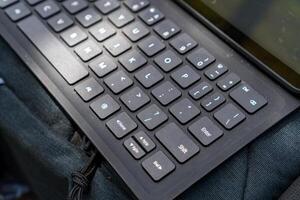 Close-up view of a keyboard for a tablet on a table, in an open room. photo