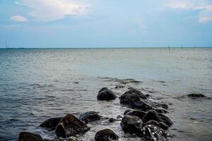 rocks on the edge of the sea to break the waves. photo