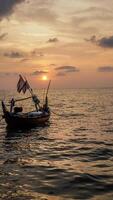 fishing boats on the sea against an orange sky at night with empty space for photocopies. photo