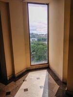 view of the city seen from the building window with sunlight shadows. photo