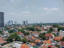 top view of people's houses with skyscrapers looking far away. photo