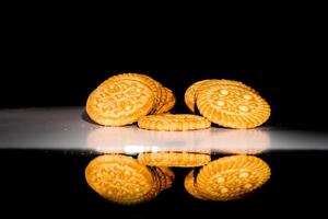 close up view of baked biscuits on black background. photo