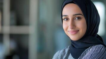 Confident female data analyst in hijab with a professional smile in an office setting showing diversity photo