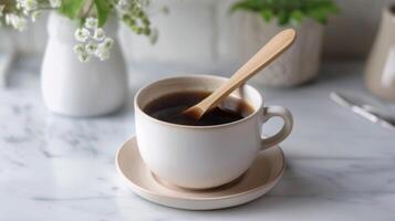 Coffee cup with wooden stirrer on a marble table for a cozy breakfast setting photo