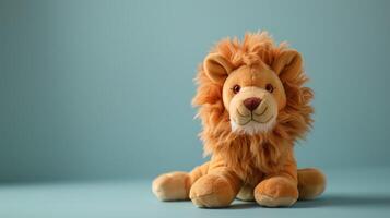 Cute plush lion toy with fluffy mane and cheerful expression on blue background photo