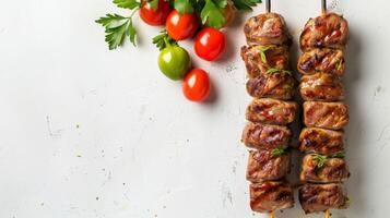 Grilled chicken skewers with fresh tomatoes and green parsley on a white background photo