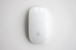 KYIV, UKRAINE - NOVEMBER 27, 2023 Apple Magic Mouse 3rd generation lies on white background photo