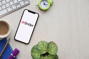 KYIV, UKRAINE - FEBRUARY 23, 2024 Tinder logo of famous dating website or app on iPhone display photo