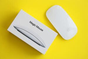 KYIV, UKRAINE - NOVEMBER 27, 2023 Apple Magic Mouse 3rd generation lies on bright colored background photo