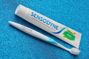 KYIV, UKRAINE - MAY 4, 2022 Sensodyne fluorine or fluor is a daily fluoride toothpaste photo