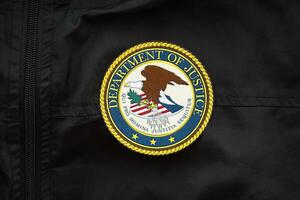 KYIV, UKRAINE - MARCH 9, 2024 US Department of Justice seal on black jacket uniform photo