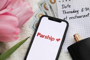 KYIV, UKRAINE - FEBRUARY 23, 2024 Parship logo of famous dating website or app on iPhone display photo