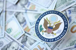 KYIV, UKRAINE - MARCH 9, 2024 US Department of State seal on many US hundred dollar bills photo