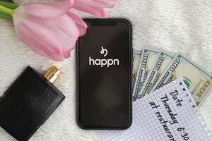 KYIV, UKRAINE - FEBRUARY 23, 2024 Happn logo of famous dating website or app on iPhone display photo