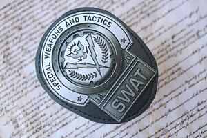 KYIV, UKRAINE - MARCH 9, 2024 US SWAT badge on United States Constitution photo