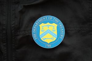 KYIV, UKRAINE - MARCH 9, 2024 US The Department of the Treasury seal on black jacket uniform photo