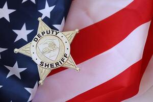 KYIV, UKRAINE - MARCH 9, 2024 US Deputy Sheriff badge on United States of America flag photo