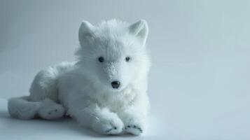 Plush toy wolf with fluffy white fur designed as a soft and cute animal plaything photo