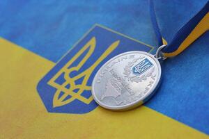 KYIV, UKRAINE - MAY 4, 2022 Medal for the person who conquered Mount Hoverla photo